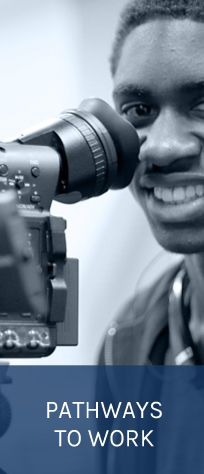 young man looking through camera - black and white